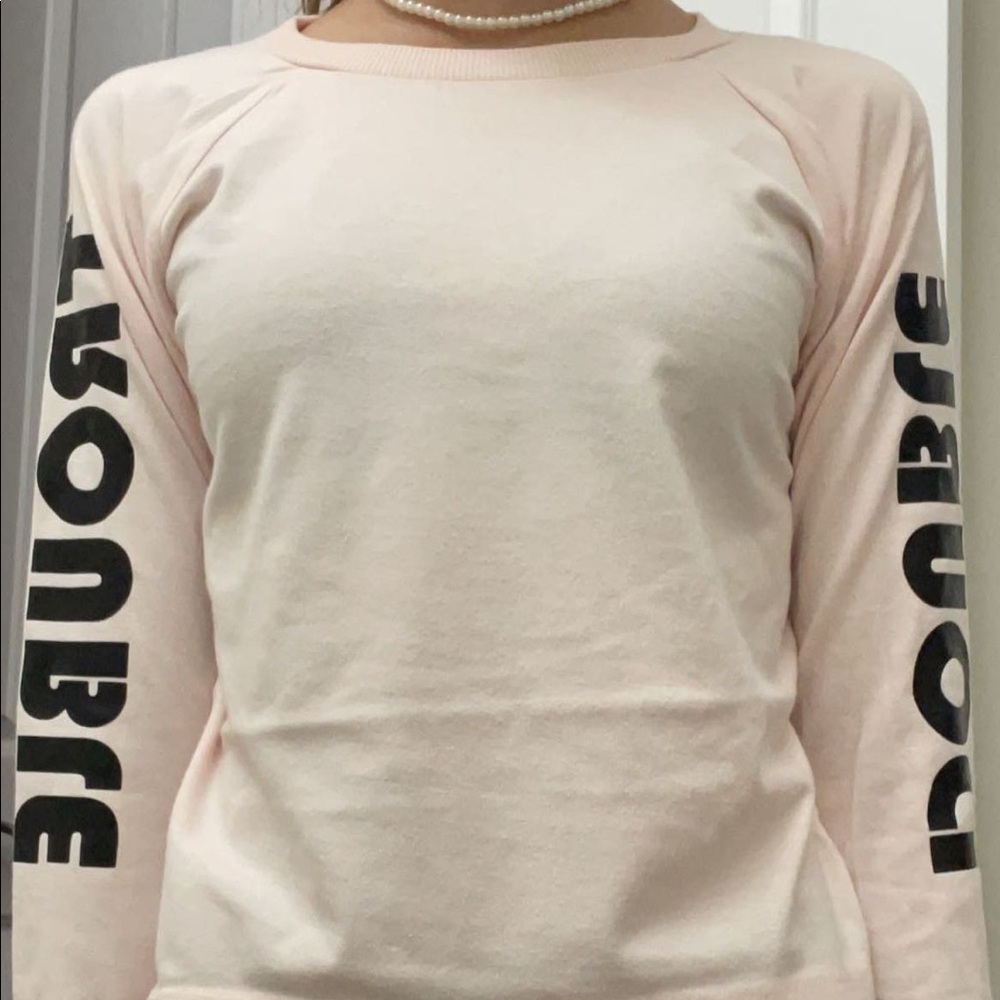 Pastel pink long sleeve with DOUBLE TROUBLE written on the long sleeves